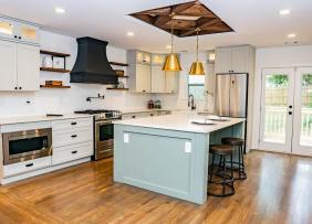 Mixed metal fixtures shown in an open kitchen with light blue island