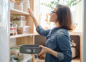 Woman looking through a kitchen pantry