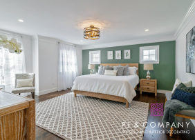 Bedroom with green accent wall staged by Patti Stern